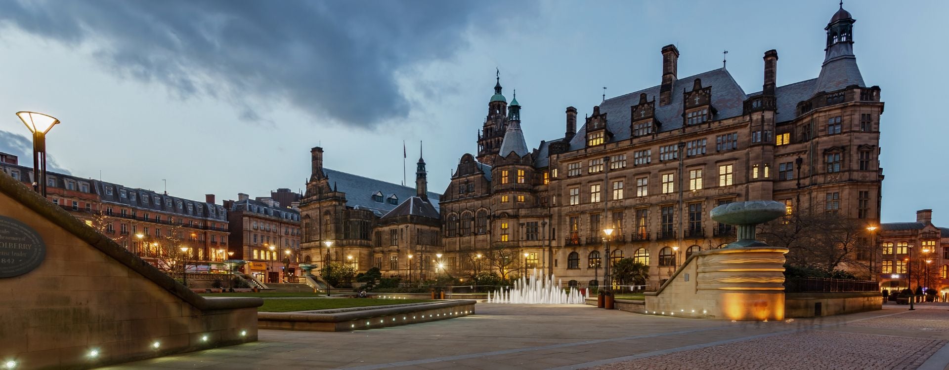 A picture of Sheffield Town Hall in Yorkshire in England. A large gothic building with a public pedestrianised square in front of it.