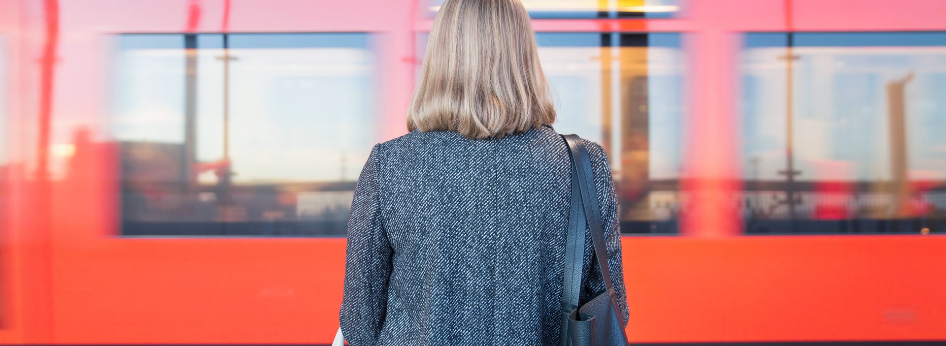 Rear-view-of-woman-standing-on-Helsinki-Metro-station
