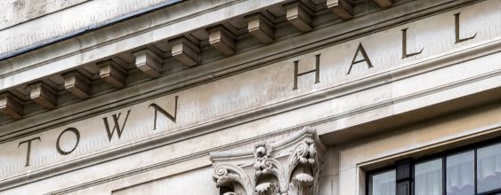A close up picture of the front of a town hall in England with the words Town Hall inscribed upon it