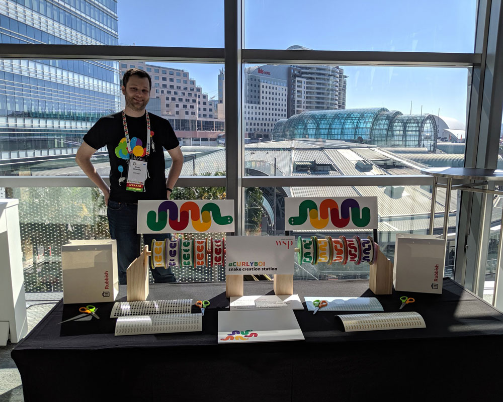 Evan Brumley presenting Curlyboi, a rainbow Python 