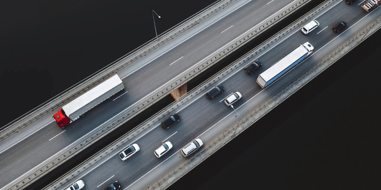 IMGAerial view of traffic vehicles driving on the highway bridge over the Neman river in Kaunas Lith