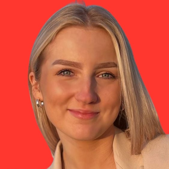 Headshot of a person with light hair against a red background.