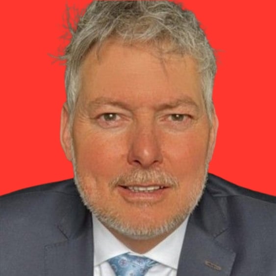 Professional headshot of a person against a red background