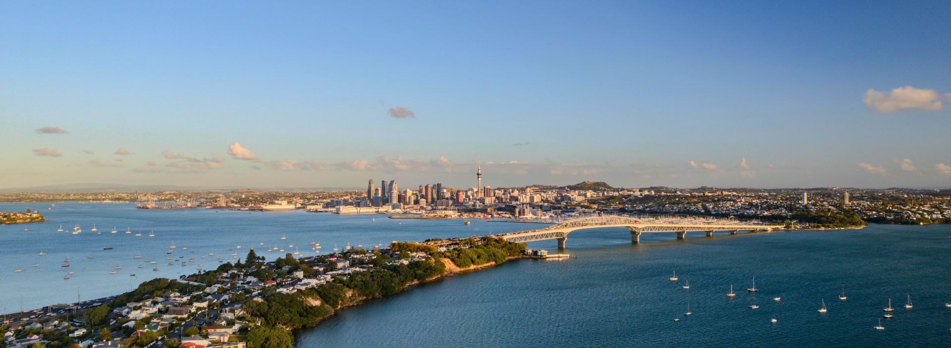 The Auckland Harbour Bridge at dusk. Taken from the North Shore with the city skyline in the distance.