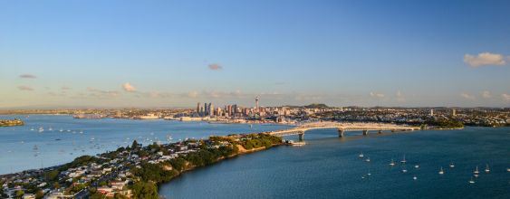 The Auckland Harbour Bridge at dusk. Taken from the North Shore with the city skyline in the distance.