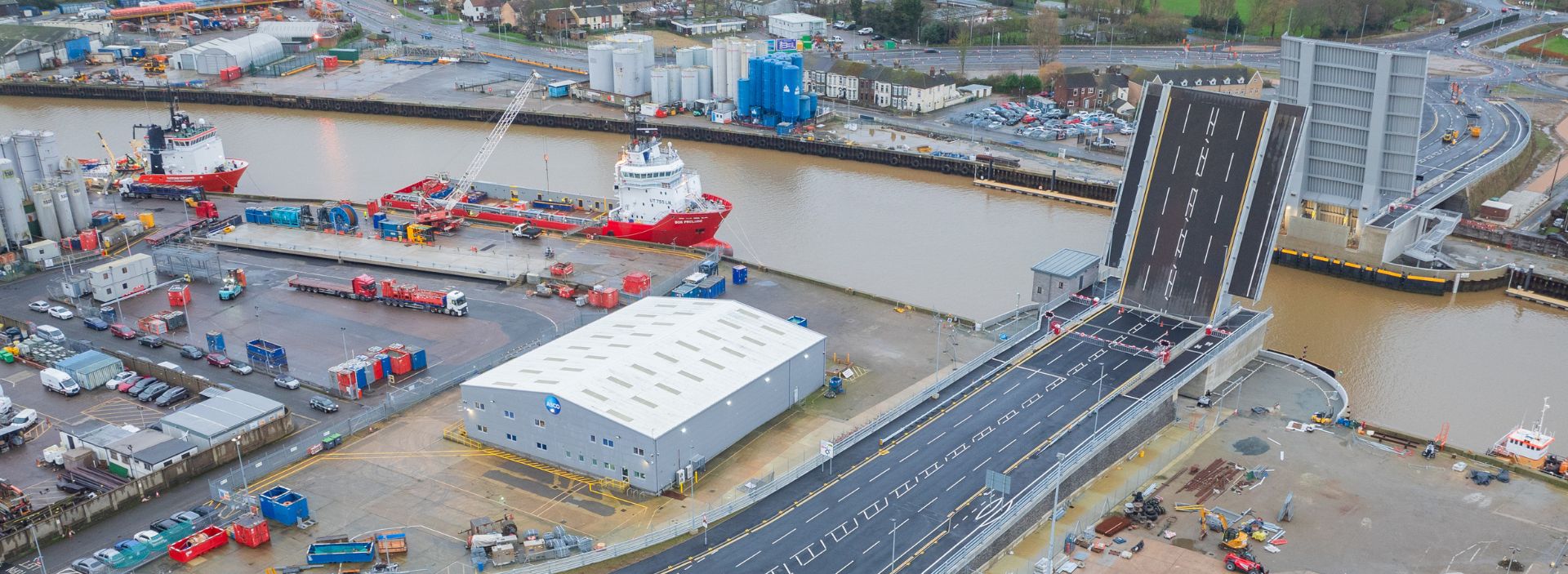 A picture of Herring Bridge in Great Yarmouth from above, showing the bridge across the River Yar with large boats on one side of it