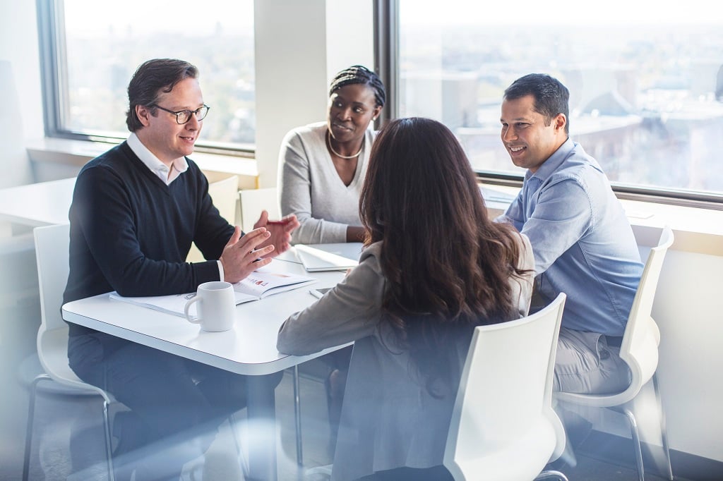 people speaking at a table
